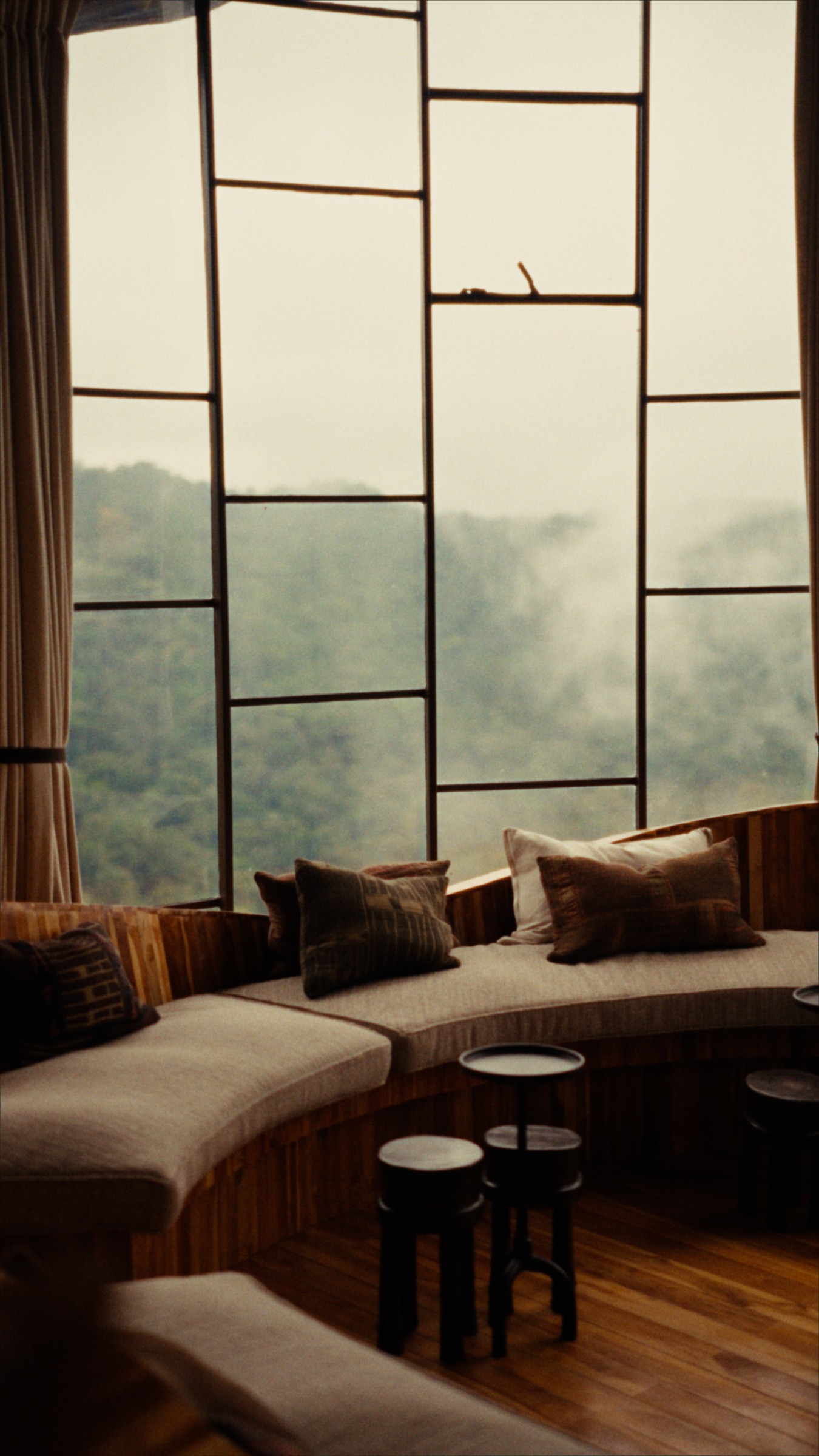 Curved seating and forest light at Erebero Hills